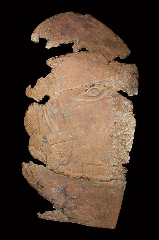 Repoussé plaque depicting human head with long-nosed ear ornaments