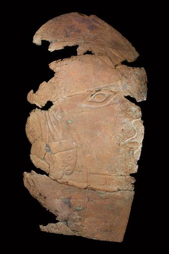 Repoussé plaque depicting human head with long-nosed ear ornaments