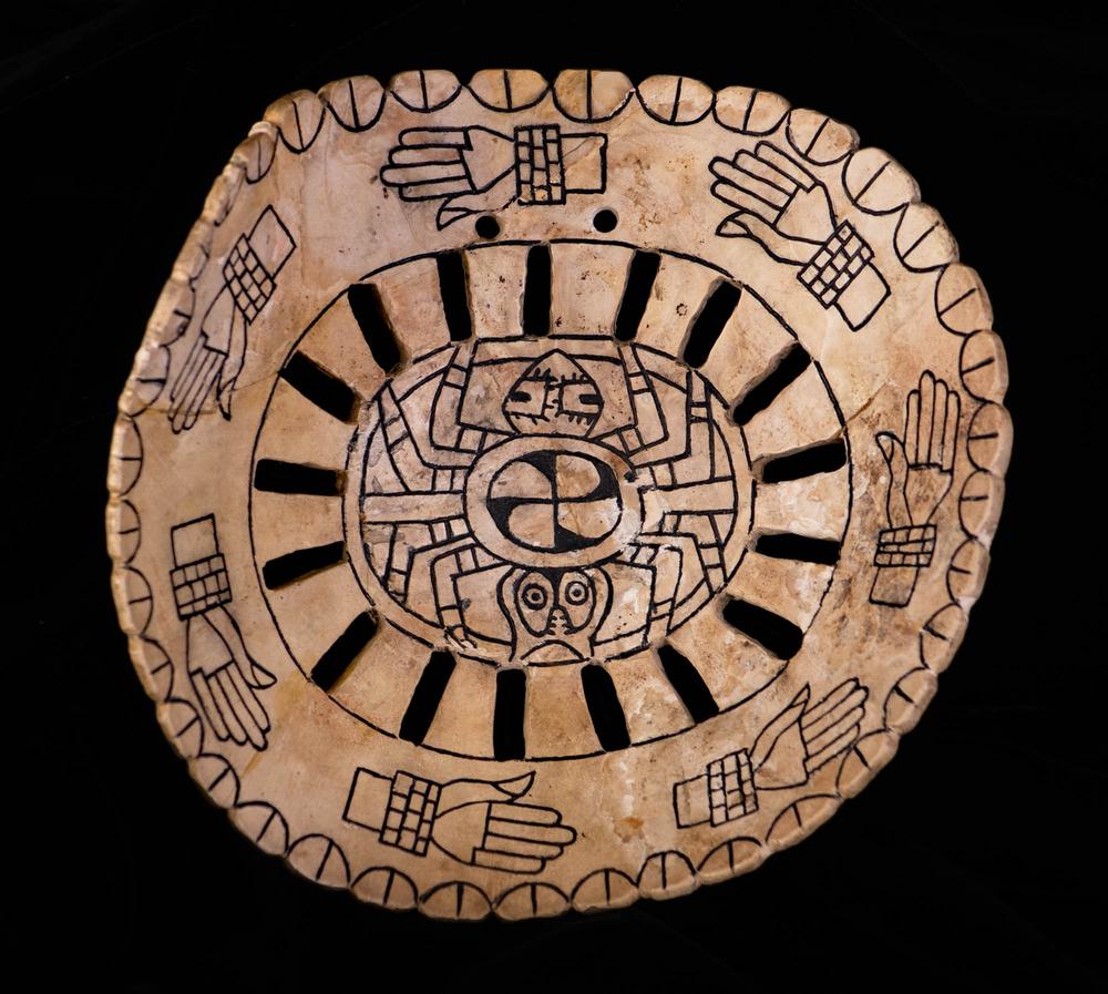 Engraved shell gorget with hands and spider