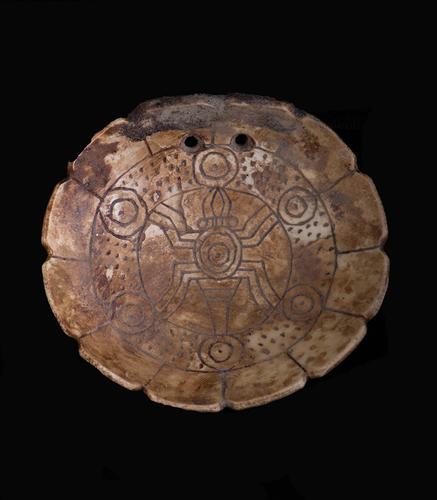 Engraved gorget with spider and cosmic motif